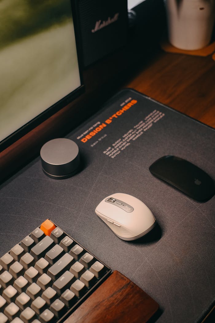 our-services-03 A stylish and organized workspace featuring a modern keyboard and mouse on a wooden desk.